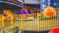 Closeup image of colorful electric cars on the carousel in amusement park at shopping mall