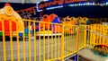 Closeup image of colorful electric cars on the carousel in amusement park at shopping mall