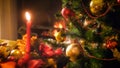 Closeup image decorated beautiful Christmas tree against burning fireplace at living room Royalty Free Stock Photo