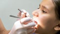 Closeup image of dentist inspecting girls teeth with instruments Royalty Free Stock Photo