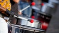 Closeup image of drum sticks in hand of street artist during the performance