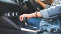 A female driver shifting automatic gear stick while driving car Royalty Free Stock Photo