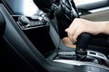 Closeup image of female driver shifting automatic gear stick while driving car. Smart wife can drive car.