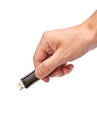 Closeup image: hand holding black USB data storage or connecting computer device with USB cable Royalty Free Stock Photo