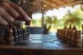 A hand holding and moving a horse in wooden chessboard game Royalty Free Stock Photo