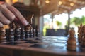 A hand holding and moving a horse in wooden chessboard game Royalty Free Stock Photo