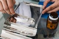 Pharmacist prepare pills in qualified counting tray by prescription at drugstore