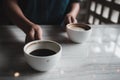 Hands holding two white cups of hot coffee on table in cafe Royalty Free Stock Photo