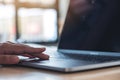 Hands using and touching on laptop touchpad on wooden table Royalty Free Stock Photo