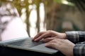 Closeup image of hands working , touching and typing on laptop keyboard with blur nature
