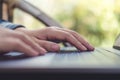 Closeup image of hands working , touching and typing on laptop keyboard with blur nature