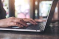 Closeup image of hands working , touching and typing on laptop keyboard