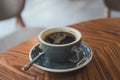 Closeup image of hot Americano coffee cup on vintage wooden table