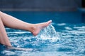 Legs and left foot kicking and splashing water in the pool Royalty Free Stock Photo