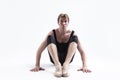 Closeup Image of Male Ballerino Dancer Sitting While Practising Stretching Exercices In Black Sportive Tights in Studio