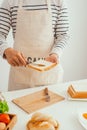 Closeup image of a male cooking whole sandwich and vegetables salad