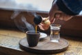 Closeup image of male hand pouring coffee in a vintage cup Royalty Free Stock Photo