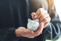 A man holding and putting coin into piggy bank for saving money and financial concept Royalty Free Stock Photo