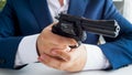 Closeup image of man in suit holding and aiming with gun Royalty Free Stock Photo