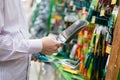 Closeup image of man or woman hands selecting or choosing for buying gardening tools like metal shovel rake