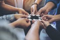 Many people hands holding a jigsaw puzzle in circle together Royalty Free Stock Photo