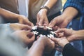 many people hands holding a jigsaw puzzle in circle together Royalty Free Stock Photo