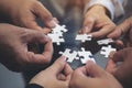 Many people hands holding a jigsaw puzzle in circle together Royalty Free Stock Photo