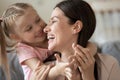 Closeup image mother daughter having fun playing embracing at home