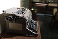 A closeup image of an old vintage type writer on a table with eroded keys with selective focus on the handle background Royalty Free Stock Photo