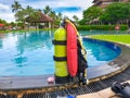 Closeup photo of oxygen cylinder for diving on the swimming pool edge Royalty Free Stock Photo