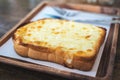 Closeup image of a piece of sliced bread toast with cheese