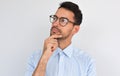 Closeup image of pleased pensive male keeps hand under chin, looking aside, on white studio background. Successful unshaven man Royalty Free Stock Photo