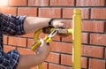 Closeup image of plumber installing new valve on yellow pipe out