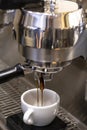 Closeup image of prepears coffee in a coffeeshop using professional coffeemachine. Royalty Free Stock Photo