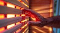 A closeup image of a professional athletes hand reaching out to adjust the temperature settings on an infrared sauna Royalty Free Stock Photo