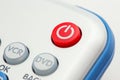 Closeup image of a red power button on a remote control