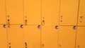 CLoseup image of straight long rows of yellow lockers in the school or college Royalty Free Stock Photo