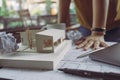 Closeup image of a stressed architects thinking and drawing shop drawing paper with architecture model and laptop on table Royalty Free Stock Photo