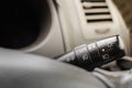 Closeup image of turn signal and lighting switch in car cockpit.