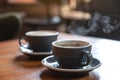 Two blue cups of hot coffee on vintage wooden table in cafe Royalty Free Stock Photo
