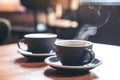 Two blue cups of hot latte coffee and Americano coffee on vintage wooden table in cafe Royalty Free Stock Photo