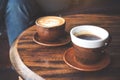 Two cups of hot latte coffee and black coffee on vintage wooden table in cafe Royalty Free Stock Photo