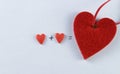 Closeup image of two red hearts with a plus and equal sign on a white background, valentines day, valentines day Royalty Free Stock Photo