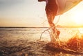 Closeup image water splashes from surfer`s legs run in ocean wit