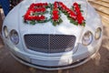 Closeup image of wedding car decoration with red and white flowers bouquet