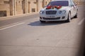 Closeup image of wedding car decoration with red and white flowers bouquet