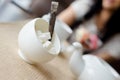 Closeup image of white pressed sugar bowls and metal spoon with tea kettle in cafe