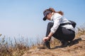 A woman hiker tying shoelaces and getting ready for trekking on the top of mountain Royalty Free Stock Photo