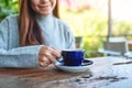 A woman holding and drinking hot coffee in the outdoors Royalty Free Stock Photo