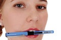 Closeup of woman`s face with pen Royalty Free Stock Photo